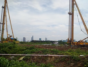 As the Bitexco Financial Tower sits just to the left of the center of the skyline, an assembly of cranes and other construction equipment begin to congregate.